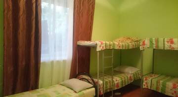 Спальное место на двухъярусной кровати в общем номере для мужчин в Гостинице Barabulka